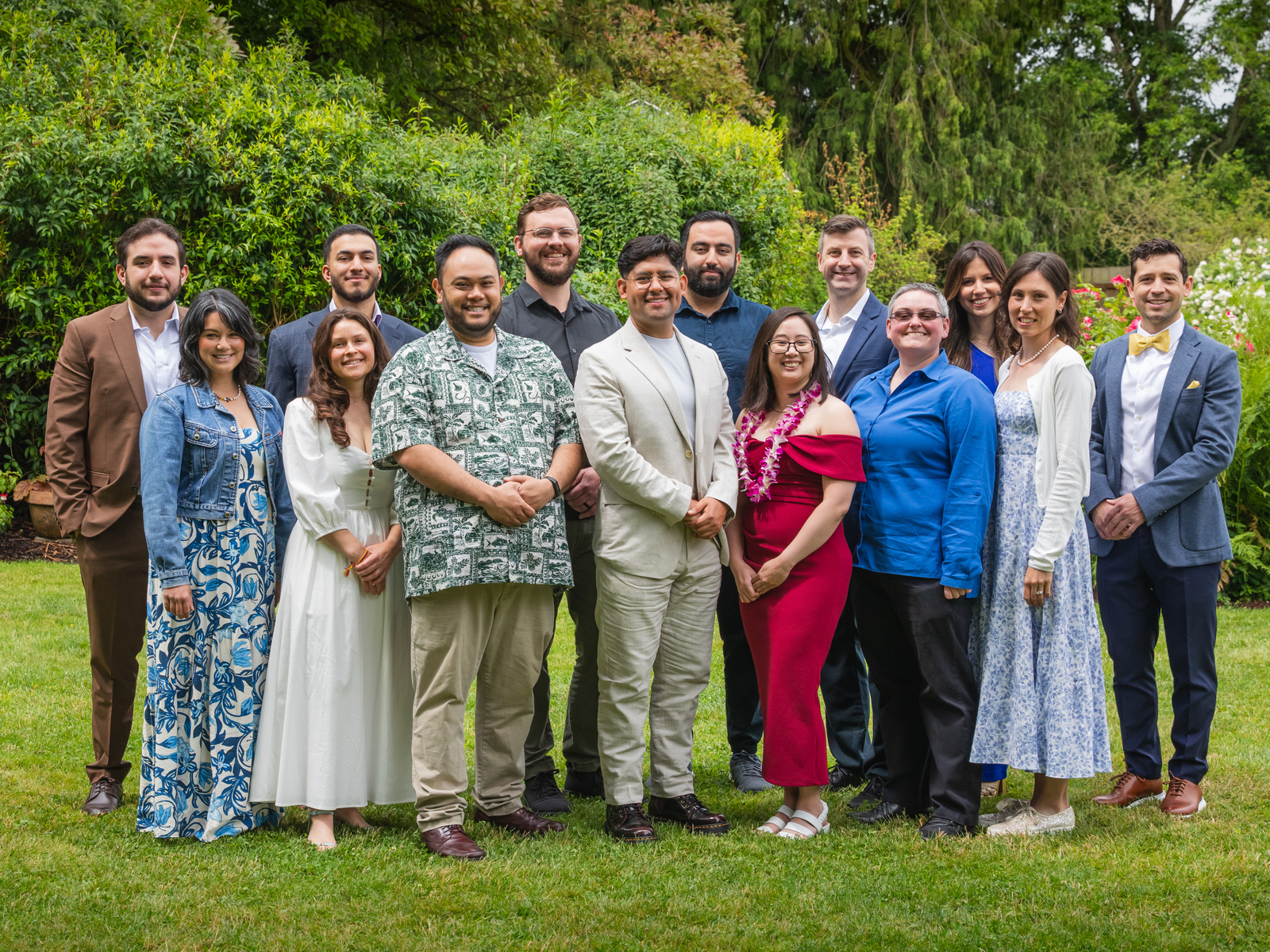 Group of internal medicine and family medicine doctors pose in a garden setting.