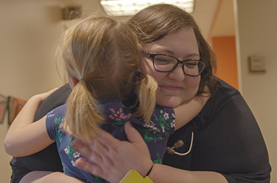 Peds nurse hugging patient