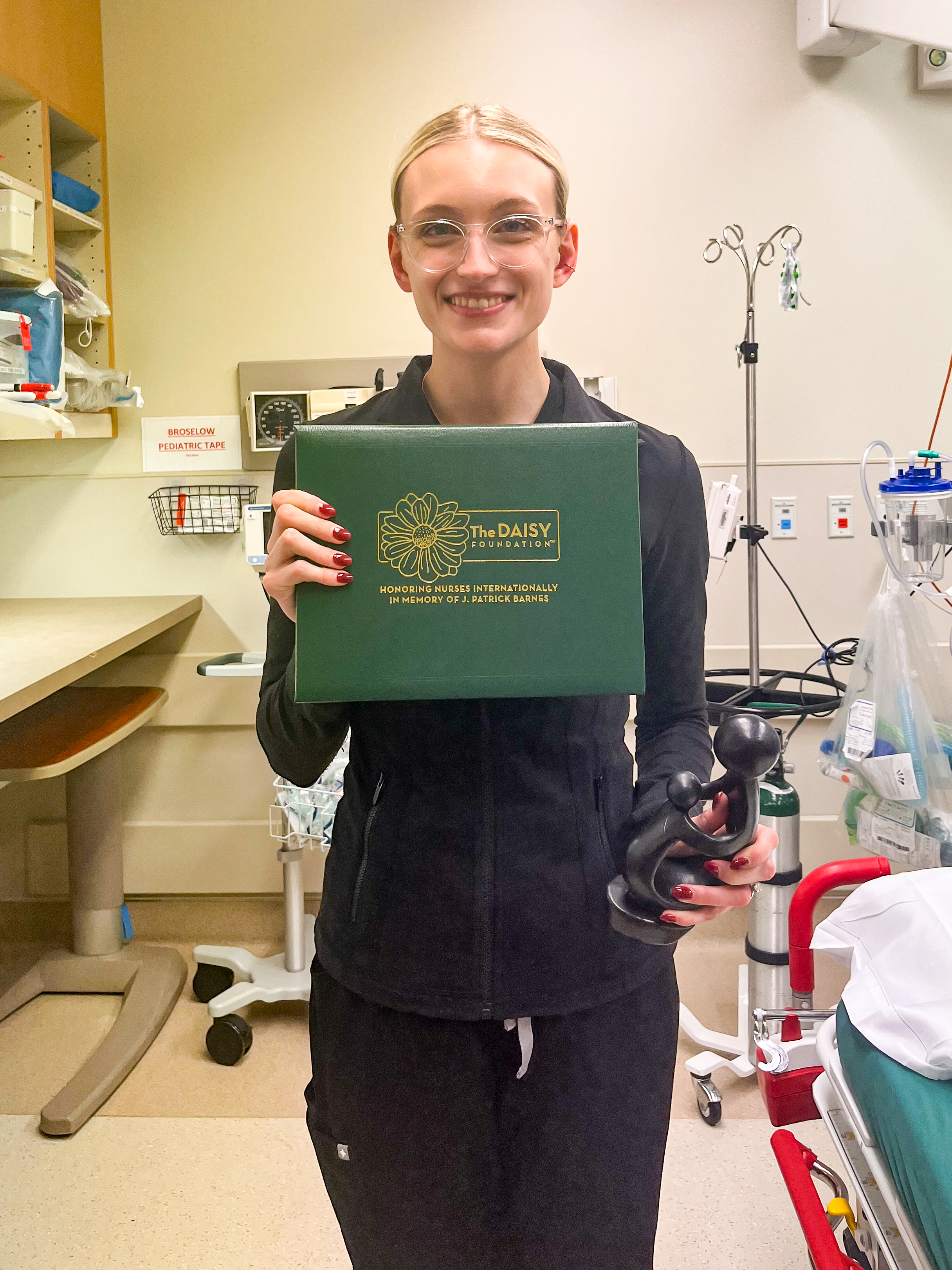 Hannah Beaumont holds DAISY Award.