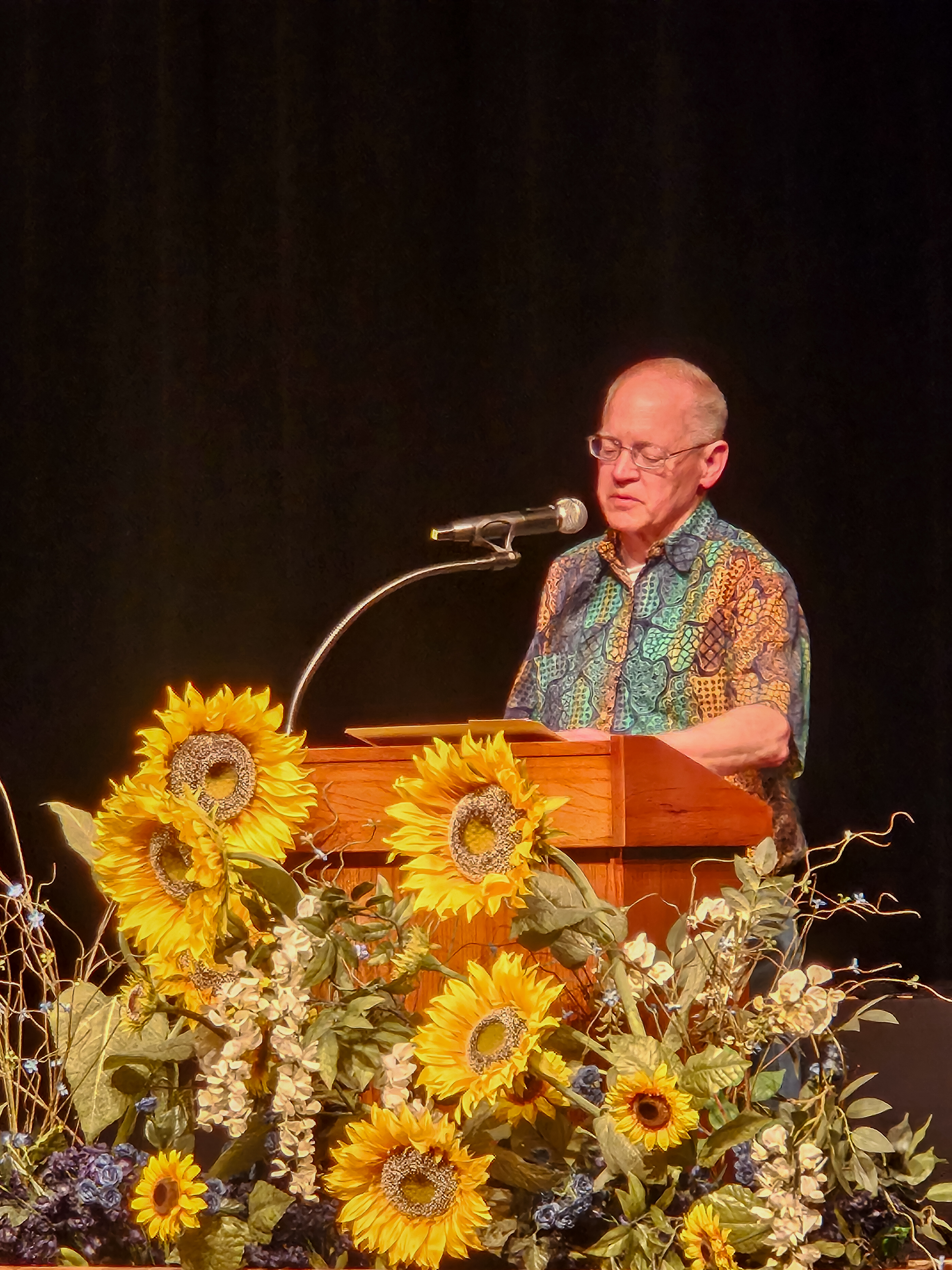 Dr. Dunnington stands on stage behind a podium.