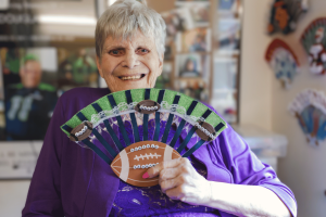 Photo of Ladena holding up a fan.
