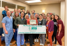 Skagit Regional Clinics - Mount Vernon Urology team hold DAISY Award banner.