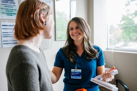 Dr. DelBello speaks with a patient in an exam room.