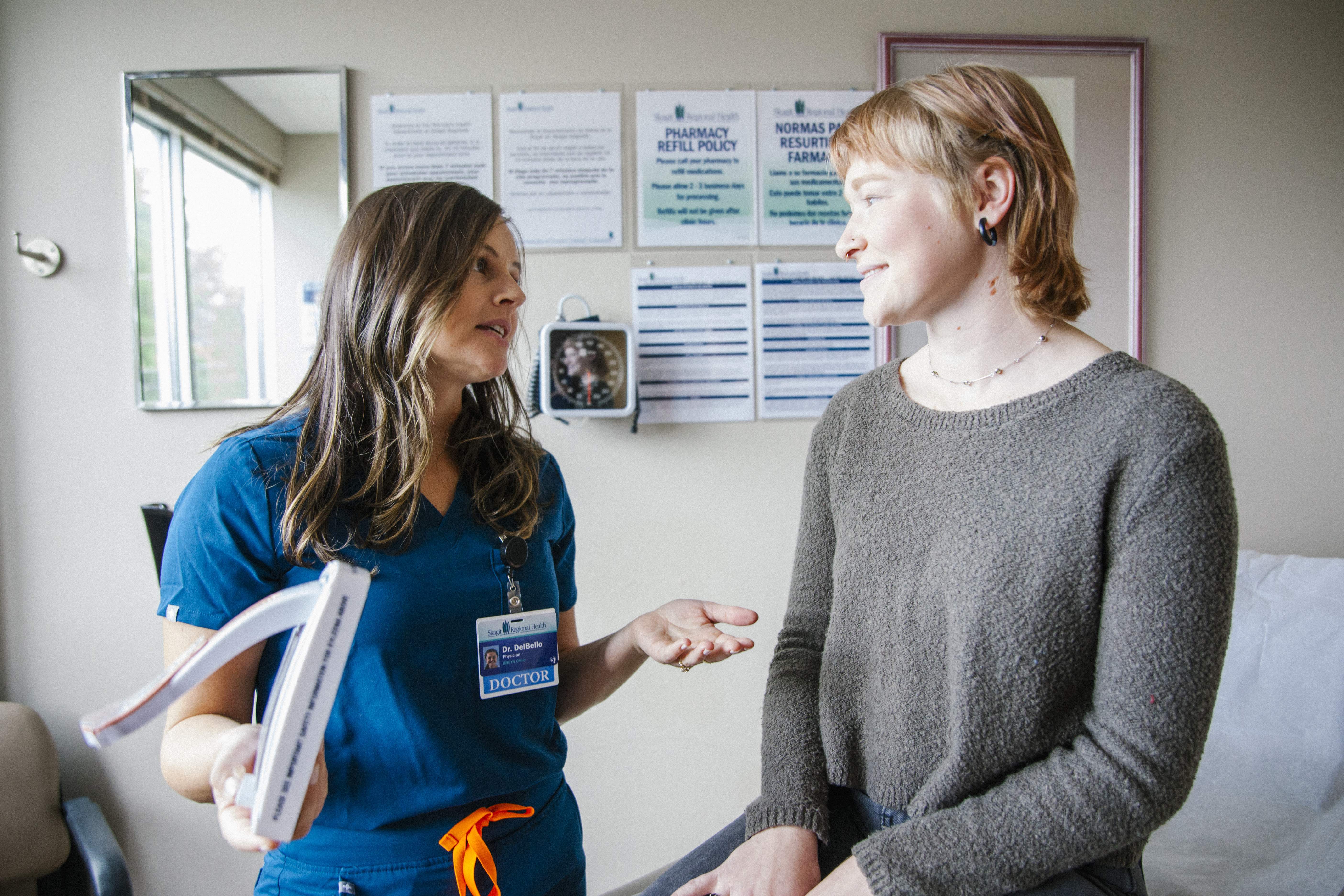 Dr. DelBello speaks with a patient in an exam room.