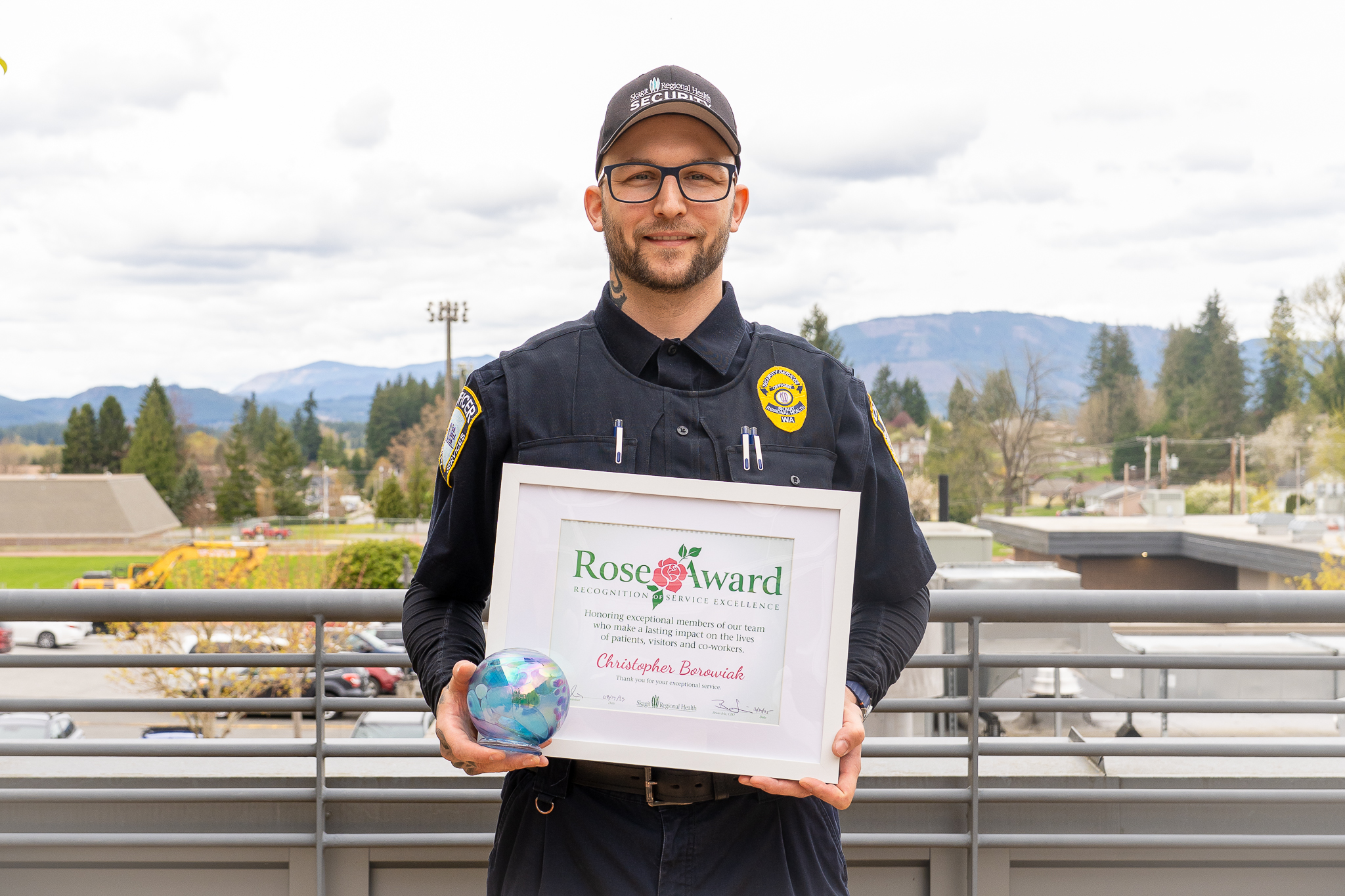 Christopher Borowiak holds Rose Award and certificate.