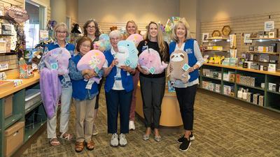 Volunteers donate stuffed animals to pediatric patients