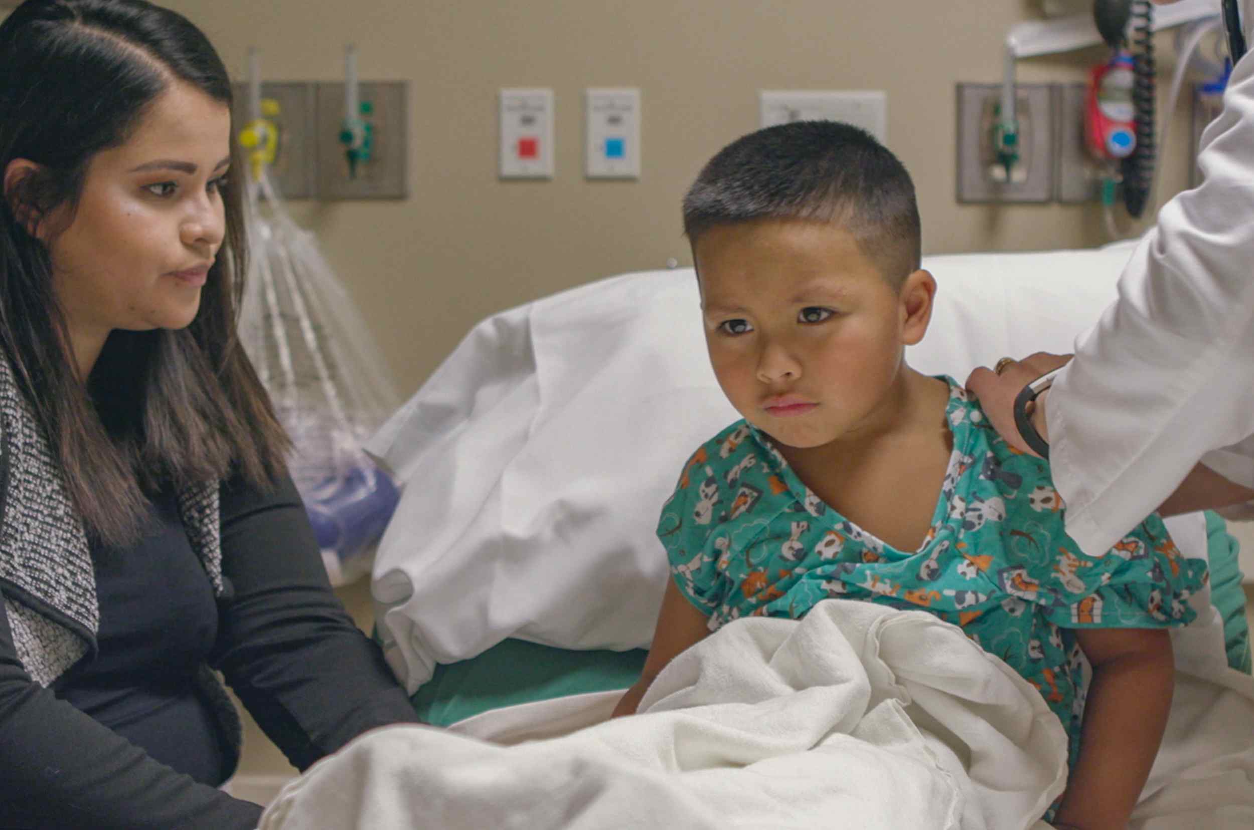 Boy in emergency room with mother alongside