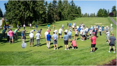 Golfers circled around a green