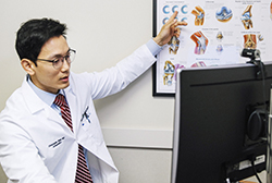 Dr. Sheu points at chart