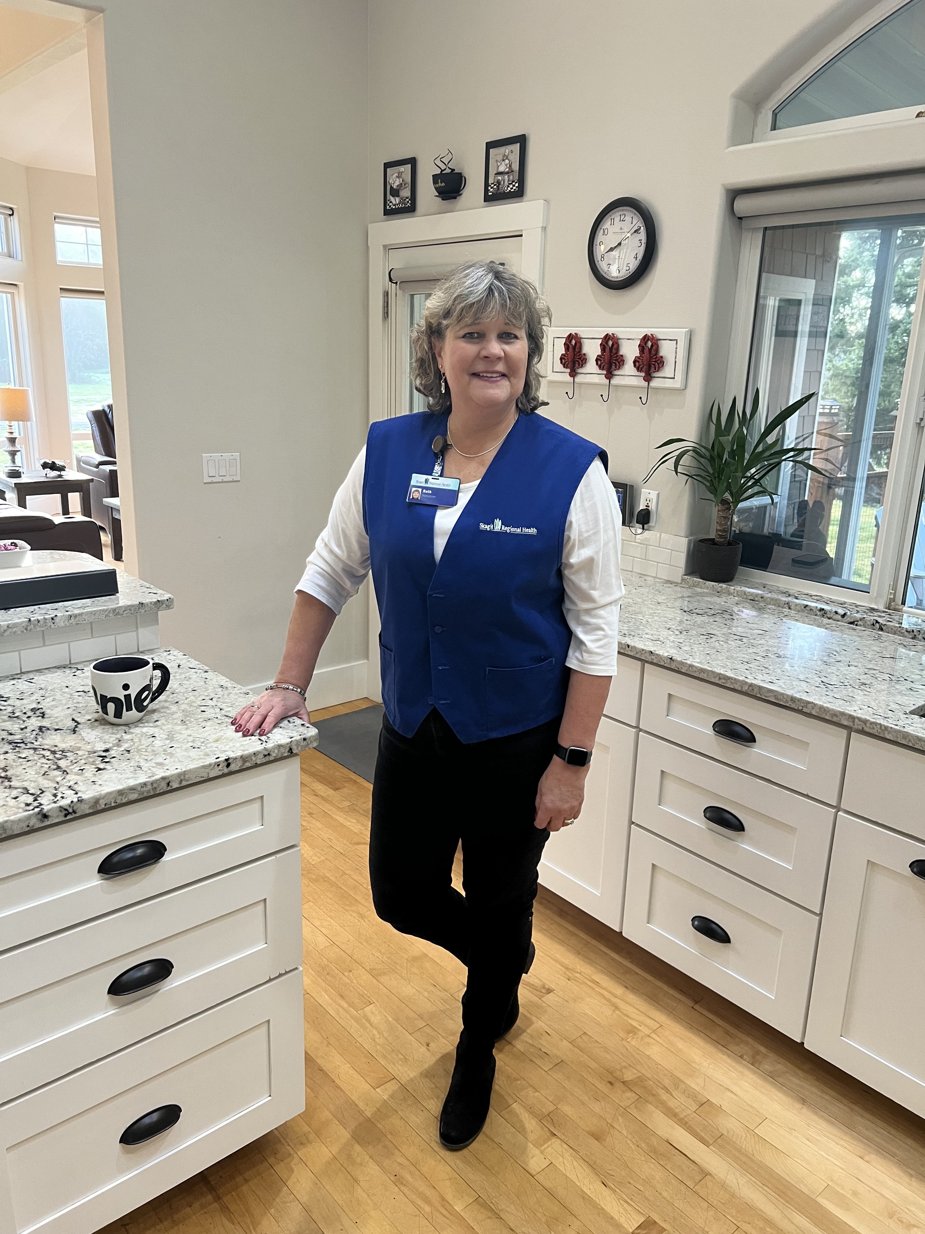 Woman wears volunteer uniform in kitchen