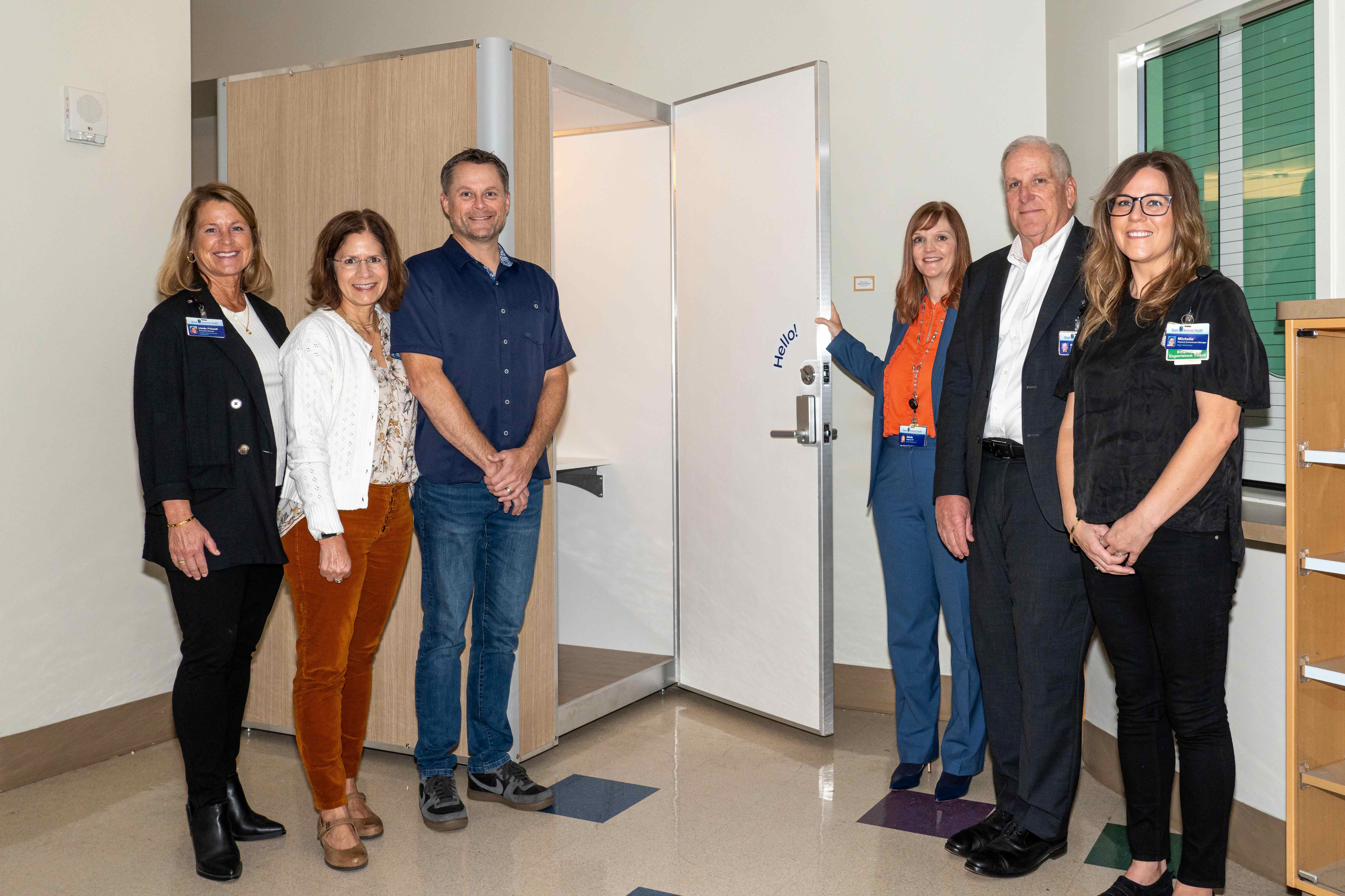 SRH Employees standing by a new lactation pod