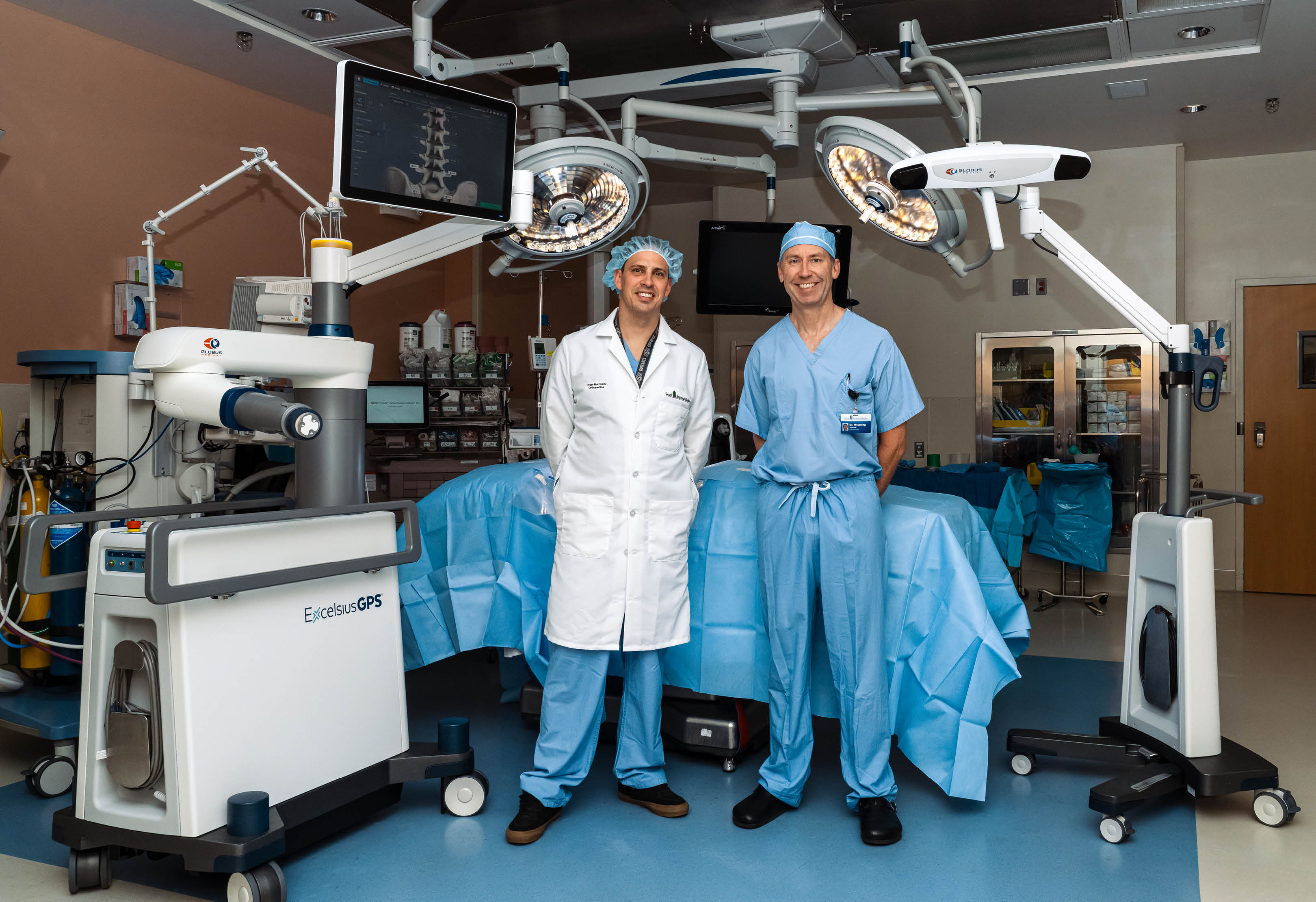 Spine surgeons in operating room with new surgical robot