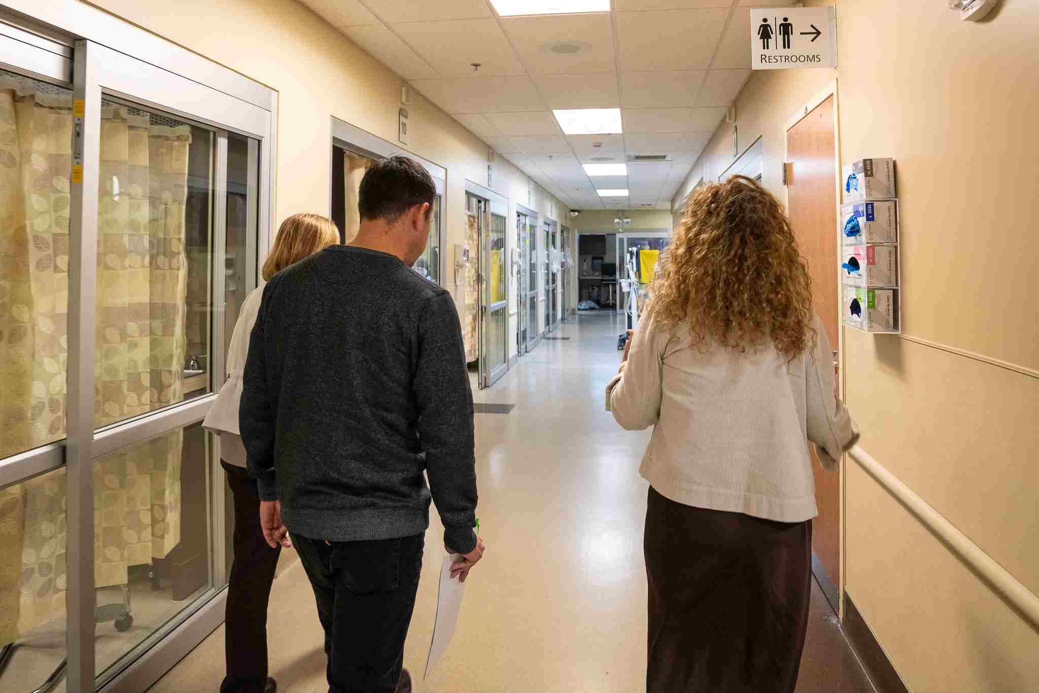 Adults walking through hospital hallway