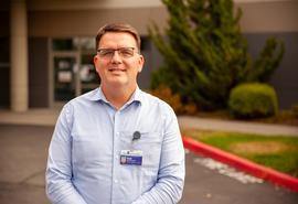 A man standing in front of a hospital ambulance bay