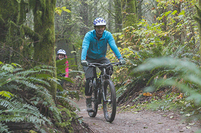 Dr, Picco rides bike through forest