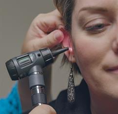 Checking ear during exam