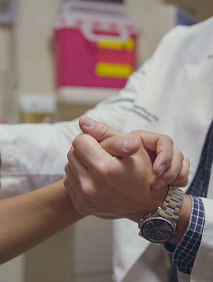 Provider looking at wrist during exam